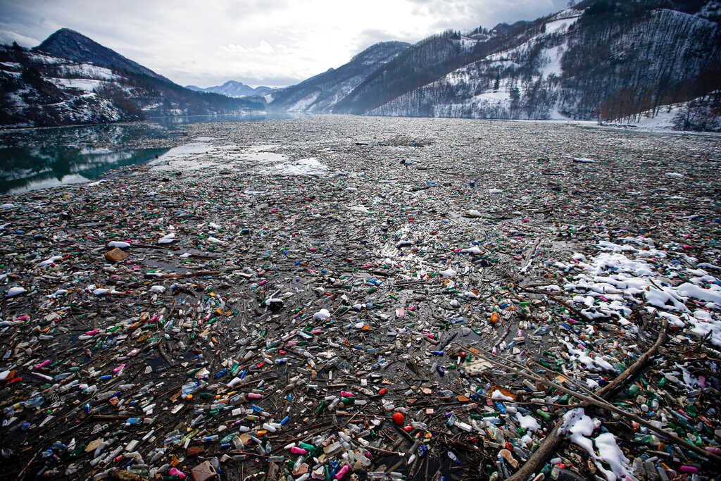 Plastic bottles and other garbage floats in the Potpecko lake near Priboj, Serbia, Jan. 22, 2021.