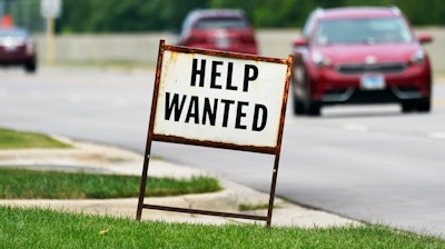 In this Tuesday, July 27, 2021, file photo, a help-wanted sign is displayed at a gas station in Mount Prospect, Ill. The gulf between record job openings and a lack of people taking those jobs is forcing Wall Street to reassess the pace of the economic recovery.