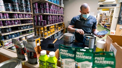 Billy Wommack, purchasing director at the W.S. Jenks & Sons hardware, opens a gallon of paint at the mixing station of the hardware store's paint department on Sept. 24 in northeast Washington.