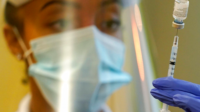 In this Jan. 8, 2021, file photo, a pharmacist prepares a syringe of the Pfizer vaccine for COVID-19, at Queen Anne Healthcare, a skilled nursing and rehabilitation facility in Seattle. The U.S. vaccination drive against COVID-19 stood on the verge of a major new phase as government advisers Thursday, Sept. 23, recommended booster doses of Pfizer's vaccine for millions of older or otherwise vulnerable Americans — despite doubts the extra shots will do much to slow the pandemic.