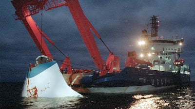 In this Nov. 19, 1994 file photo, the bow door of the sunken passenger ferry M/S Estonia is lifted up from the bottom of the sea, off Uto Island, in the Baltic Sea, near Finland. A privately-funded expedition, commissioned by relatives of the victims of the M/S Estonia ferry that sank into the Baltic Sea nearly 27 years ago, will dive into the vessel’s wreckage this month, Sept. 2021.