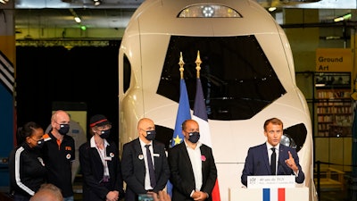 French President Emmanuel Macron speaks in front of a life-size replica of the next high-speed train TGV, at the Gare de Lyon station Friday, Sept. 17, 2021 in Paris.