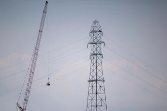 In this Friday, Sept. 3, 2021, file photo, Entergy contractors prepare to detonate transmission lines that fell into the Mississippi River Harahan, in New Orleans, after a tower collapsed during Hurricane Ida.