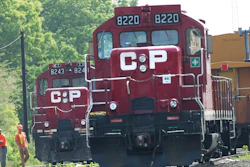 In this May 23, 2012, file photo, surveyors work next to Canadian Pacific Rail trains which are parked on the train tracks in Toronto. A planned shareholder vote on Canadian National's $33.6 billion offer has been delayed, Wednesday, Sept. 1, 2021, after regulators rejected a key part of the plan, so now Kansas City Southern can consider all of its options, including a competing $31 billion offer from Canadian Pacific Railway.