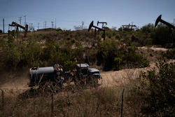 A truck drives past pump jacks operating at the Inglewood Oil Field, Thursday, June 10, 2021, in Los Angeles.