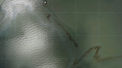 Photos captured by National Oceanic and Atmospheric Administration aircraft Tuesday, Aug. 31, 2021 and reviewed by The Associated Press show a miles long black slick floating in the Gulf of Mexico near a large rig marked with the name Enterprise Offshore Drilling.