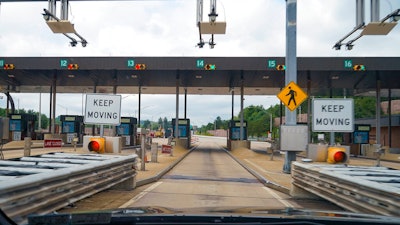 In this photo made through a windshield, the sensors and lights are seen at the west bound toll gate of the Pennsylvania Turnpike in Cranberry Township, Pa., on Monday, Aug. 30, 2021. More than $104 million in Pennsylvania Turnpike tolls went uncollected last year as the agency fully converted to all-electronic tolling. Turnpike records show the millions of motorists who don’t use E-ZPass have a nearly 1 in 2 chance of riding without paying under the “toll-by-plate” license plate reader system.