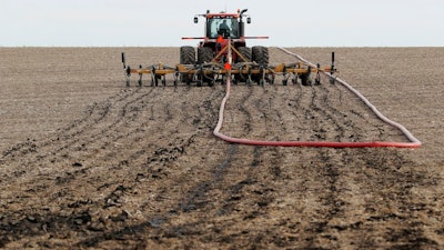 Injecting manure into a field as fertilizer in Lawler, Iowa. Manure management is a major source of greenhouse gas emissions from livestock.