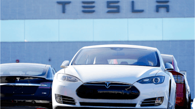 An unsold 2021 S70 sedan at a Tesla dealership.