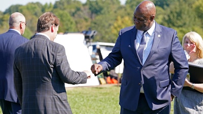 United Auto Workers President Ray Curry, right, bumps fists with Jim Farley, Ford president and CEO, left, after a presentation on the planned factory to build electric F-Series trucks and the batteries to power future electric Ford and Lincoln vehicles Tuesday, Sept. 28, 2021, in Memphis, Tenn. The plant in Tennessee is to be built near Stanton, Tenn.