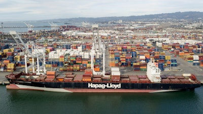 The Rotterdam Express is seen at the Port of Oakland, Wednesday, Oct. 6, 2021 in Oakland, Calif. The Rotterdam Express, a massive cargo ship made a series of unusual movements while anchored in the closest spot to a Southern California oil pipeline that ruptured and sent crude washing up on beaches, according to data collected by a marine navigation service.