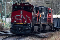 In this Nov. 27, 2020 file photo, a Canadian National rail worker stands on an idle locomotive as protesters opposed to the Trans Mountain pipeline expansion block rail lines in Burnaby, British Columbia. After walking away from its effort to buy Kansas City Southern railroad earlier this month, Canadian National continues to face investor pressure to make changes in its operation. The London-based investment firm TCI Fund — which owns about 5% of CN’s stock — is pressing for CN to overhaul its board, get a new CEO and improve its own operations.