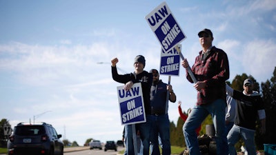 Members of the United Auto Workers strike outside of the John Deere Engine Works plant on Ridgeway Avenue in Waterloo, Iowa, on Friday, Oct. 15, 2021. About 10,000 UAW workers have gone on strike against John Deere since Thursday at plants in Iowa, Illinois and Kansas.