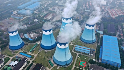 In this Sept. 27, 2021 file photo, steam billows out of the cooling towers at a coal-fired power station in Nanjing in east China's Jiangsu province. The world's facing an energy crunch.