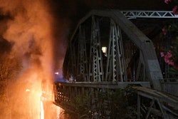 Flames engulf the Industry Bridge in Rome, early Sunday, Oct. 3, 2021. A blaze, possibly sparked by a gas canister explosion, destroyed part of an historic bridge spanning the Tiber River in Rome before firefighters extinguished the flames early Sunday.