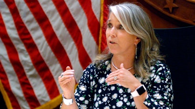 In this July 29, 2021, file photo New Mexico Gov. Michelle Lujan Grisham speaks at a news conference in Santa Fe, N.M. Grisham is returning to the podium next week at an annual gathering of oil executives. She's also contemplating attendance at the U.N. Climate Conference in Scotland in November, internal emails show.