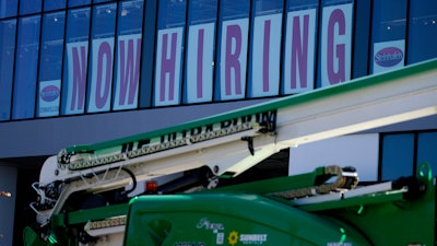 A hiring sign is displayed at a furniture store window on Friday, Sept. 17, 2021, in Downers Grove, Ill. Unemployment claims dropped 6,000 to 290,000 last week, the third straight drop, the Labor Department said Thursday, Oct. 21, 2021.