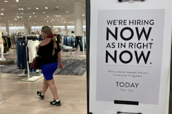 In this May 21, 2021 file photo, a customer walks behind a sign at a Nordstrom store seeking employees in Coral Gables, Fla. On Friday, Oct. 8, U.S. employers added just 194,000 jobs in September, a second straight tepid gain and evidence that the pandemic still has a grip on the economy with many companies struggling to fill millions of open jobs.