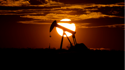 In this Wednesday, April 8, 2020 file photo, the sun sets behind an idle pump jack near Karnes City, USA. The OPEC oil cartel and allied countries are meeting to decide on production. The meeting is being closely watched because oil markets are tight and the price of crude is just off a three-year high as the global economy bounces back from the pandemic.