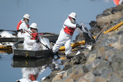 Cleanup contractors unload collected oil in plastic bags trying to stop further oil crude incursion into the Wetlands Talbert Marsh in Huntington Beach, Calif., Sunday, Oct. 3, 2021. One of the largest oil spills in recent Southern California history fouled popular beaches and killed wildlife while crews scrambled Sunday to contain the crude before it spread further into protected wetlands.