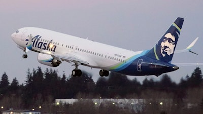 In this Monday, March 1, 2021 file photo, The first Alaska Airlines passenger flight on a Boeing 737-9 Max airplane takes off on a flight to San Diego from Seattle-Tacoma International Airport in Seattle. A Boeing pilot involved in testing the 737 Max jetliner was indicted Thursday, Oct. 14,2021 by a federal grand jury on charges of deceiving safety regulators who were evaluating the plane, which was later involved in two deadly crashes.