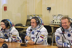 In this handout photo released by Roscosmos, actress Yulia Peresild, left, film director Klim Shipenko, right, and cosmonaut Anton Shkaplerov speak with their relatives through a safety glass prior the launch at the Baikonur Cosmodrome, Kazakhstan, Tuesday, Oct. 5, 2021.