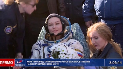 In this photo taken from video footage released by Roscosmos Space Agency, actress Yulia Peresild sits in a chair shortly after the landing of the Russian Soyuz MS-18 space capsule, southeast of the Kazakh town of Zhezkazgan, Kazakhstan, Sunday, Oct. 17, 2021.