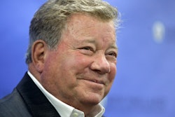 In this May 6, 2018 file photo, actor William Shatner takes questions from reporters after delivering the commencement address at New England Institute of Technology graduation ceremonies, in Providence, R.I. Star Trek’s Captain Kirk is rocketing into space this month — boldly going where no other sci-fi actors have gone.