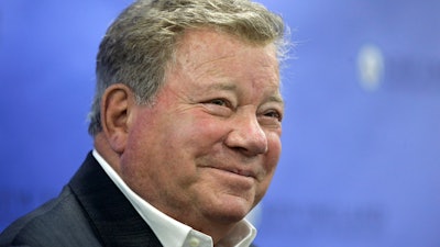 In this May 6, 2018 file photo, actor William Shatner takes questions from reporters after delivering the commencement address at New England Institute of Technology graduation ceremonies, in Providence, R.I. Star Trek’s Captain Kirk is rocketing into space this month — boldly going where no other sci-fi actors have gone.
