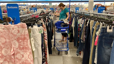 In this July 21,2021 photo, a consumer shops at a retail store in Morton Grove, Ill. U.S. consumer spending accelerated in August despite the surge in COVID cases, while the additional demand combined with supply shortages kept inflation high.