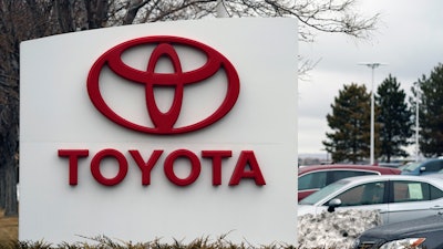 In this Sunday, March 21, 2021 file photo, the company logo adorns a sign outside a Toyota dealership in Lakewood, Colo. Nippon Steel Corp. is suing Toyota Motor Corp. over a patent for technology key for electric motors in a rare case of legal wrangling between Japan’s top steelmaker and automaker over intellectual property.
