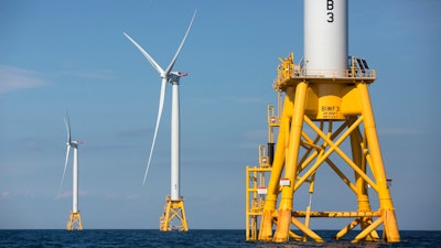 In this Aug. 15, 2016 file photo, three of Deepwater Wind's five turbines stand in the water off Block Island, R.I, the nation's first offshore wind farm. Interior Secretary Deb Haaland says the Biden administration will hold lease sales for up to seven offshore wind farms on the East and West coasts and in the Gulf of Mexico in the next four years.