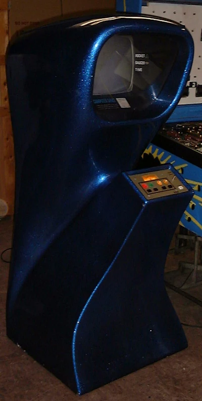 A coin-operated Computer Space game seen next to a pinball machine.