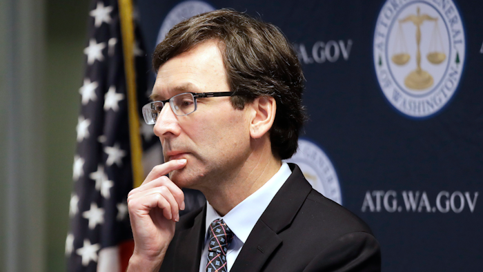 Washington state Attorney General Bob Ferguson looks on during a news conference in Seattle on Dec. 17, 2019. Ferguson rejected a half-billion-dollar settlement offer, and now he's taking the state's case against the nation's three biggest drug distributors to trial Monday, Nov. 15, 2021. He says they must be held accountable for their role in the opioid crisis.