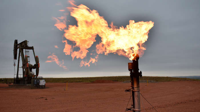 A flare burns natural gas at an oil well, Watford City, N.D., Aug. 26, 2021.