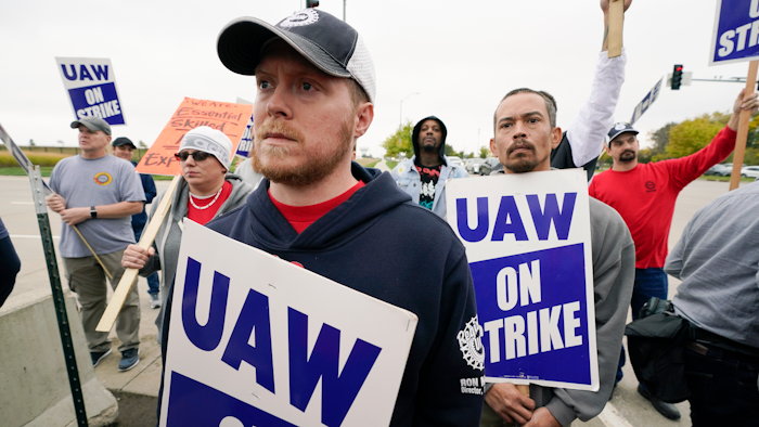 Members of the United Auto Workers listen to Agriculture Secretary Tom Vilsack speak outside of a John Deere plant, Wednesday, Oct. 20, 2021, in Ankeny, Iowa. About 10,000 UAW workers have gone on strike against John Deere since last Thursday at plants in Iowa, Illinois and Kansas.