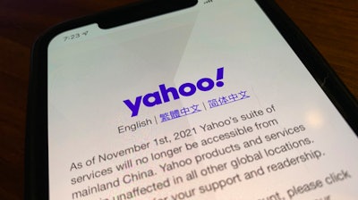 A smart phone shows the home page of Yahoo when accessed inside China in Beijing, China, Tuesday, Nov. 2, 2021. Yahoo Inc. on Tuesday said it plans to pull out of China, citing an 'increasingly challenging business and legal environment.'