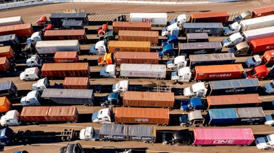 Trucks line up to enter a Port of Oakland shipping terminal on Nov. 10, 2021, in Oakland, CA.