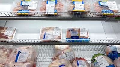 A near empty case of different chicken cuts is displayed at a Publix Supermarket on Oct. 20, 2021 in Miami.