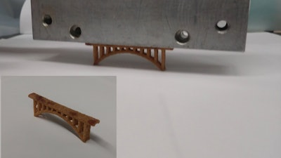 A novel polymer developed at Oak Ridge National Laboratory strengthens sand for additive manufacturing applications. A 6.5 centimeter 3D-printed sand bridge, shown here, held 300 times its own weight.