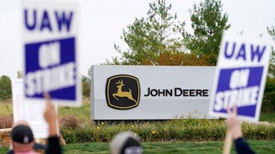 Members of the United Auto Workers strike outside of a John Deere plant, Wednesday, Oct. 20, 2021, in Ankeny, Iowa.