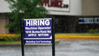A hiring sign is displayed in Downers Grove, Ill., on June 24, 2021. The number of Americans applying for unemployment benefits fell to a fresh pandemic low last week, Thursday, Nov. 4, another sign the job market is healing after last year’s coronavirus recession. Jobless claims dropped by 14,000 to 269,000 last week.