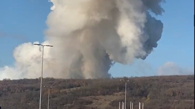 Smoke billows following a blast in the outskirts of Belgrade, Serbia, Tuesday, Nov. 22, 2021. Serbia’s state RTS television has reported that a series of explosions ripped through an munitions factory on the outskirts of Belgrade, killing at least 2 workers and injuring at least 16.