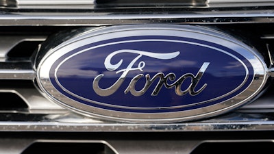 In this April 25, 2021 file photograph, the blue oval logo of Ford Motor Company is shown in east Denver. Ford Motor Co. is in talks with a computer chip maker GlobalFoundaries Inc. to shore up its semiconductor supplies as it tries to avoid factory shutdowns in the future.