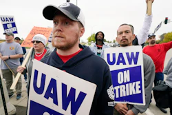 Members of the United Auto Workers listen to Agriculture Secretary Tom Vilsack speak outside of a John Deere plant, Wednesday, Oct. 20, 2021, in Ankeny, Iowa. About 10,000 UAW workers have gone on strike against John Deere since last Thursday at plants in Iowa, Illinois and Kansas.