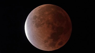 The earth's shadow covers the full moon during a partial lunar eclipse, early Friday, Nov. 19, 2021, in Kansas City, Mo. NASA and the nation's top federal nuclear research lab on Friday, Nov. 19, put out a request for proposals for a fission surface power system.