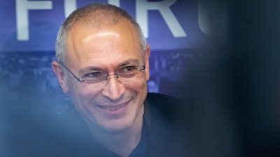 Russian opposition figure and former owner of the Yukos Oil Company Mikhail Khodorkovsky smiles during a news conference after the Vilnius Russia Forum at the 'Esperanza' hotel in Paunguriai village, Trakai district west of the capital Vilnius, Lithuania, on Aug. 20, 2021. The Dutch Supreme Court is ruling Friday, Nov. 5, 2021 in a $50 billion legal battle between Russia and former shareholders of the country's bankrupted oil giant Yukos.