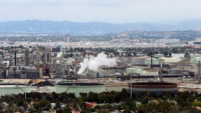 This aerial photo shows the Standard Oil Refinery in El Segundo, Calif., with Los Angeles International Airport in the background and the El Porto neighborhood of Manhattan Beach, Calif., in the foreground, May 25, 2017.