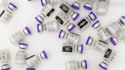 Vials of the Pfizer-BioNTech COVID-19 vaccine sit in a cooler before being thawed at a pop-up COVID-19 vaccination site in the Bronx borough of New York on Tuesday, Jan. 26, 2021. On Tuesday, Nov. 9, 2021, Pfizer asked U.S. regulators to allow boosters of its COVID-19 vaccine for anyone 18 or older.