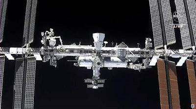 This image made from NASA TV shows the international space station, seen from the SpaceX Crew Dragon spacecraft Saturday, April 24, 2021. NASA called off a spacewalk Tuesday, Nov. 30, because of menacing space junk that could puncture an astronaut's suit or damage the International Space Station.